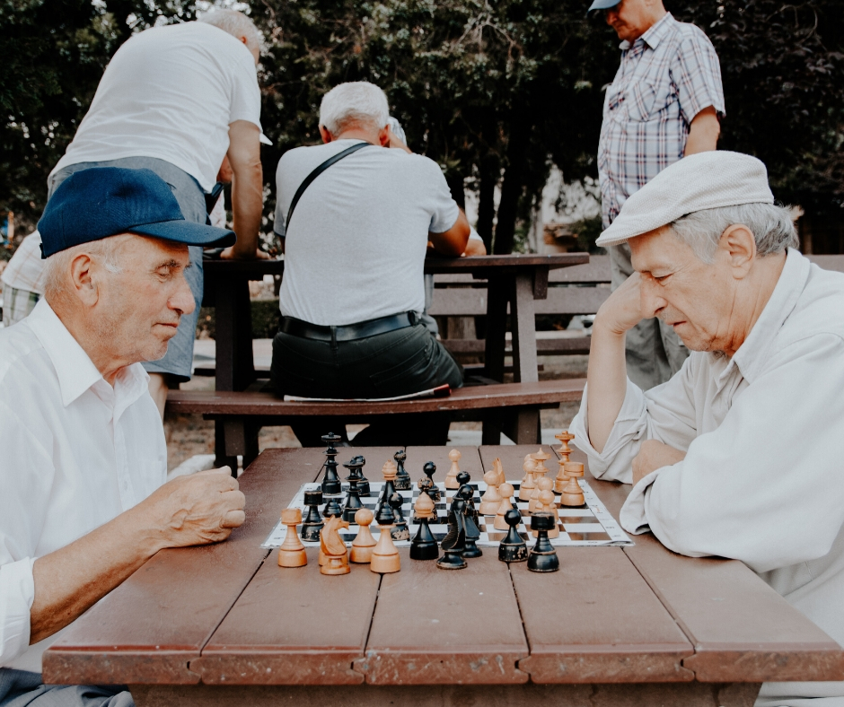 Older Men Playing Chess In The Park