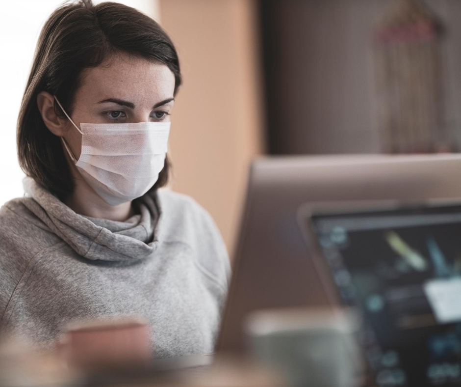 Woman In Face Covering Working On Computer
