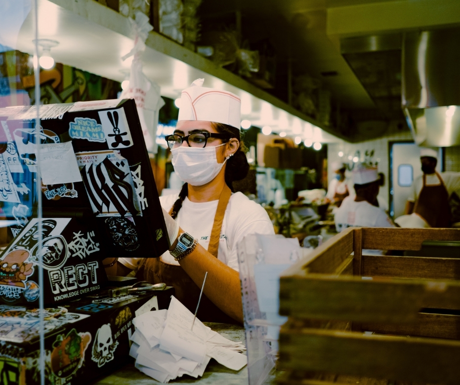 Woman In Face Covering Entering Order Into Register