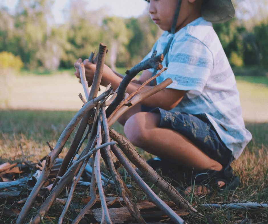 Child Building A Campfire