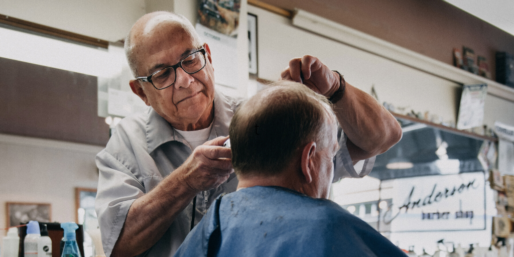 Man Getting Haircut At Barber Shop