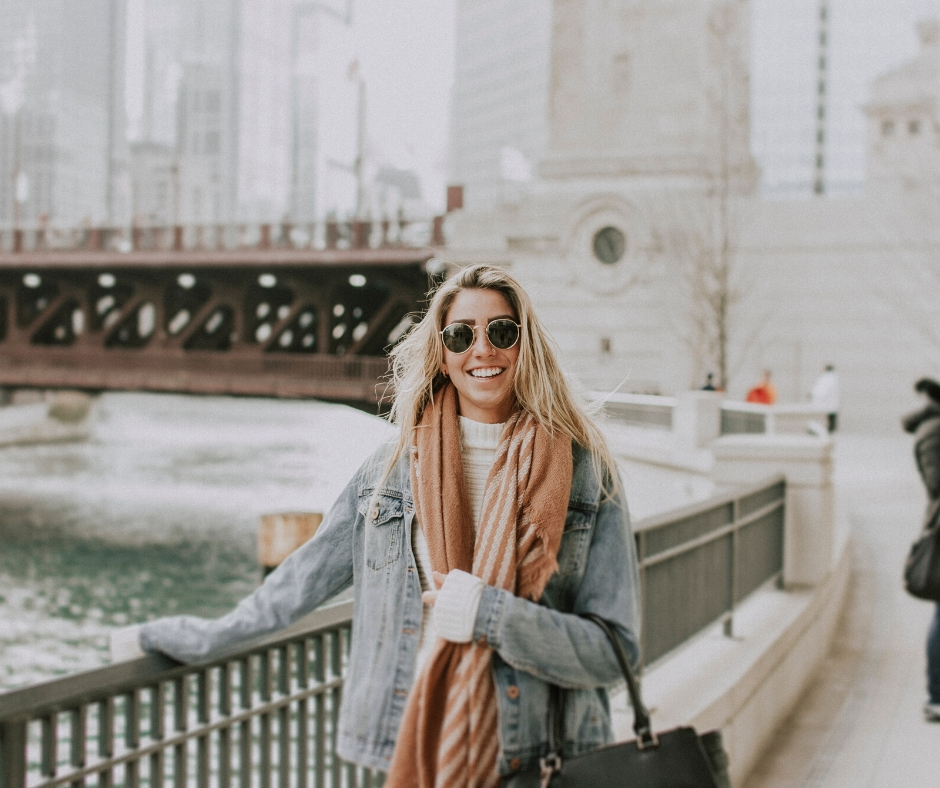 Woman Stands Near Fence At River